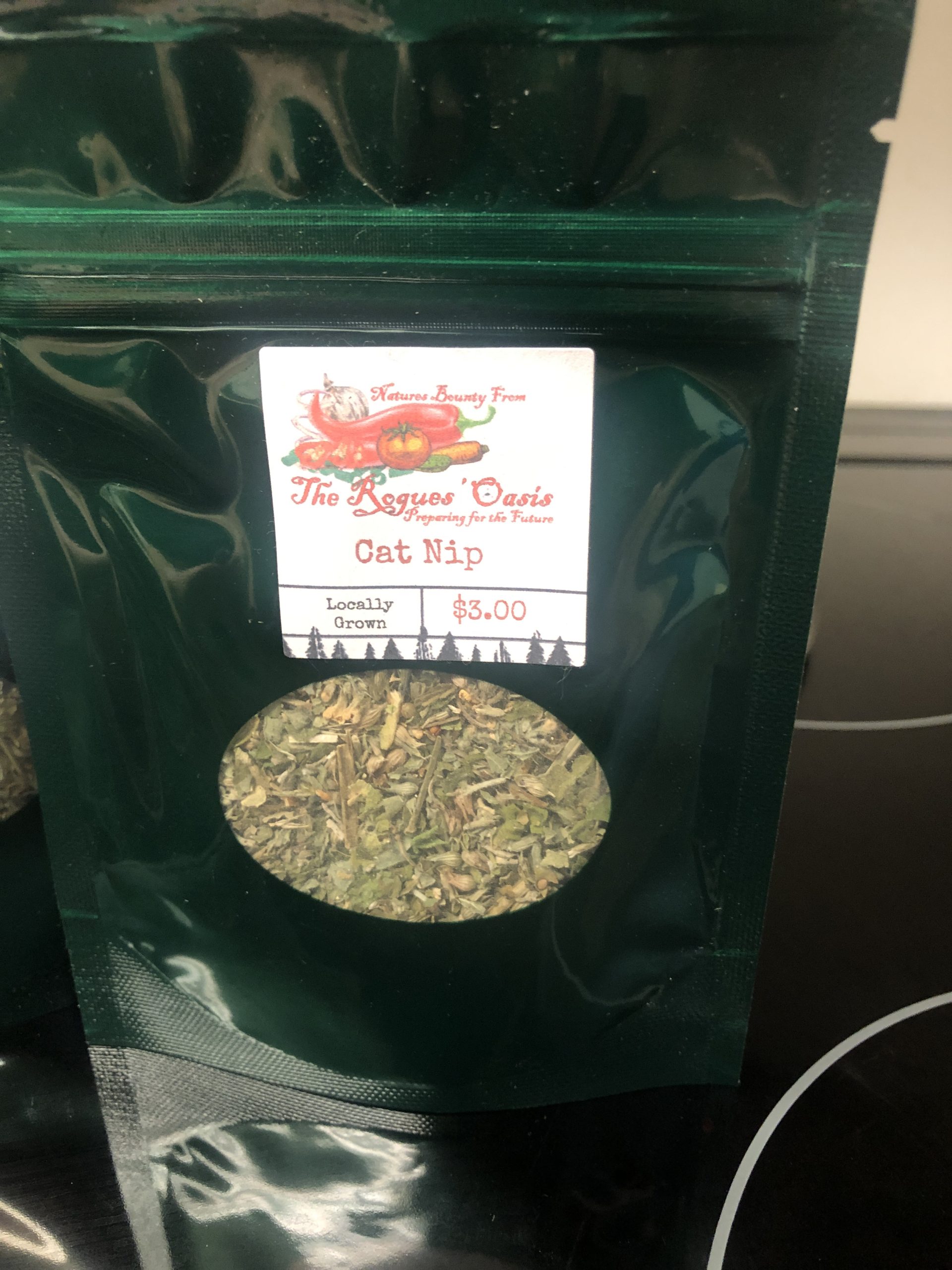 A green package of locally grown catnip from The Rogues' Oasis, priced at $3.00.