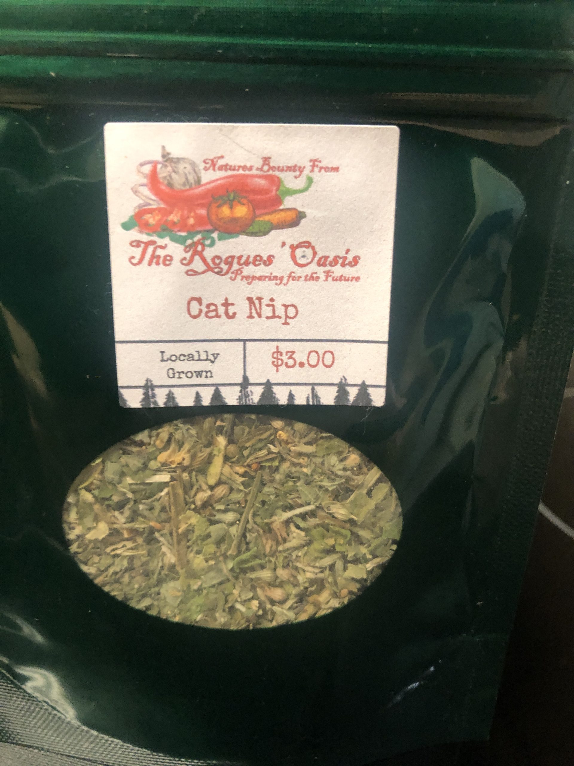 Locally grown catnip from The Rogues' Oasis, packaged in a dark green bag with a rustic label.