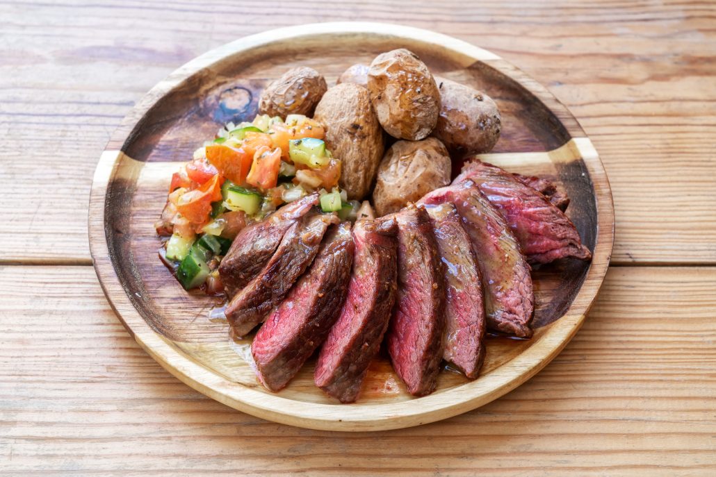 Nice healthy meal rare steal for lovers with salad and baked potatoes.