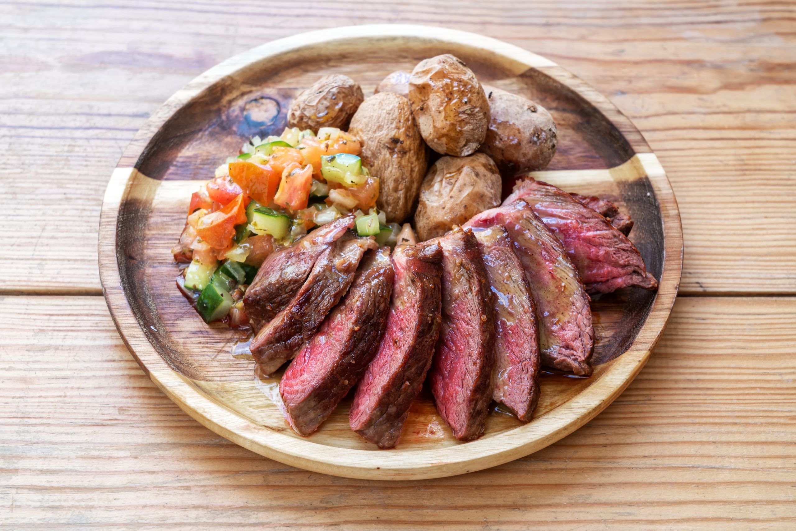 Nice healthy meal rare steal for lovers with salad and baked potatoes.