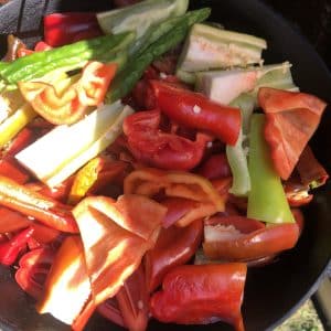 Vibrant sliced peppers in a black skillet, ready to enhance culinary creations.