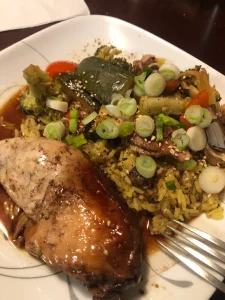 Succulent honey soy chicken with vibrant veggies on golden turmeric rice.