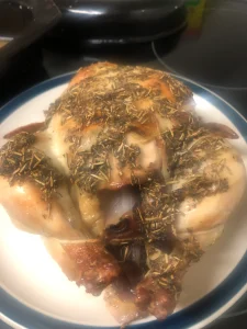 A succulent roast chicken with a golden-brown crust and herbal tallow rub.