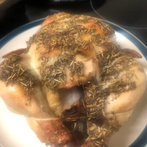 A succulent roast chicken with a golden-brown crust and herbal tallow rub.